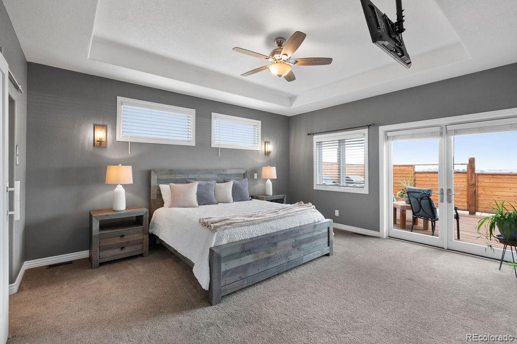 3050 Native Court Wellington, CO 80549 - Photo 22 of 50 a bedroom with a bed and a chandelier