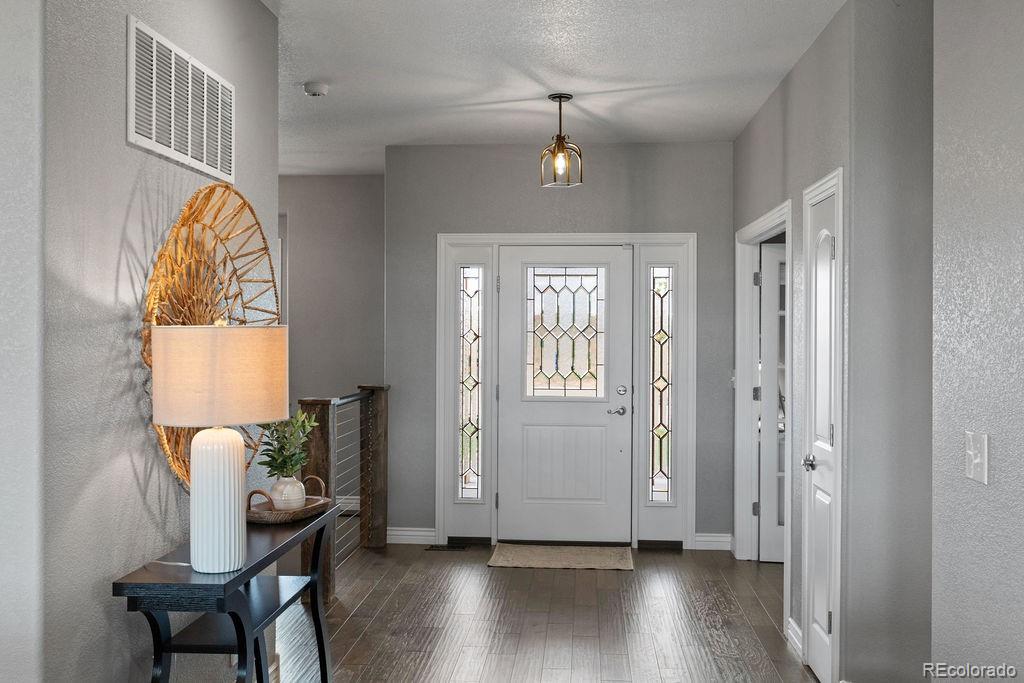 3050 Native Court Wellington, CO 80549 - Photo 3 of 50 a view of a dining room with furniture window and wooden floor