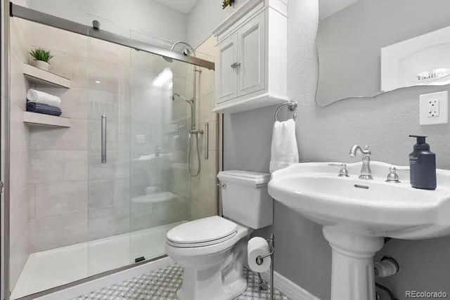 a bathroom with a sink toilet and shower