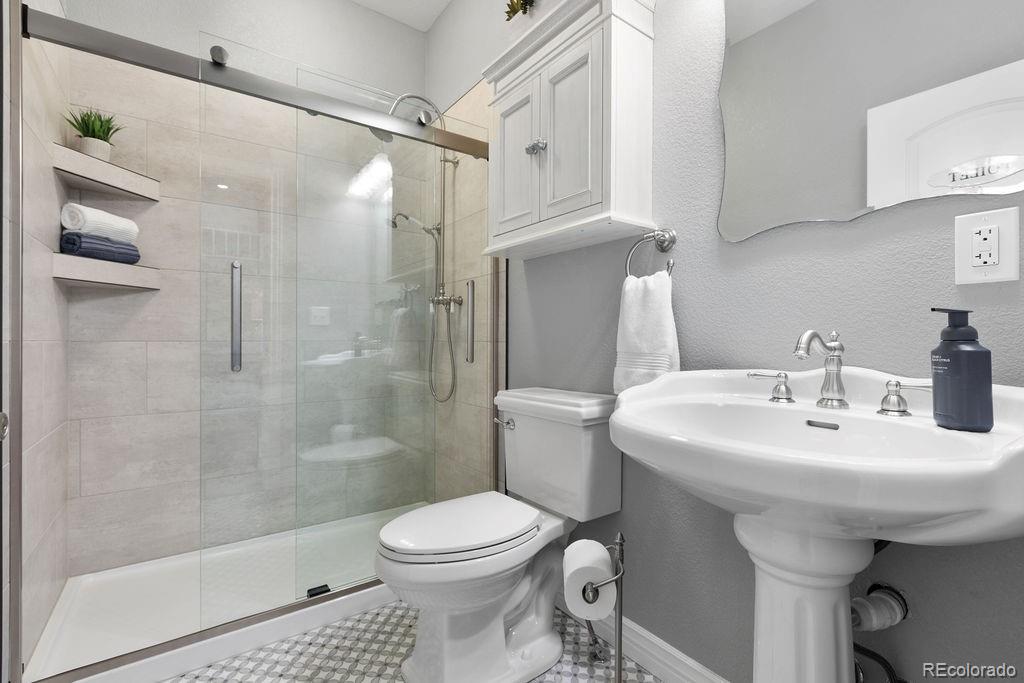 3050 Native Court Wellington, CO 80549 - Photo 31 of 50 a bathroom with a sink toilet and shower