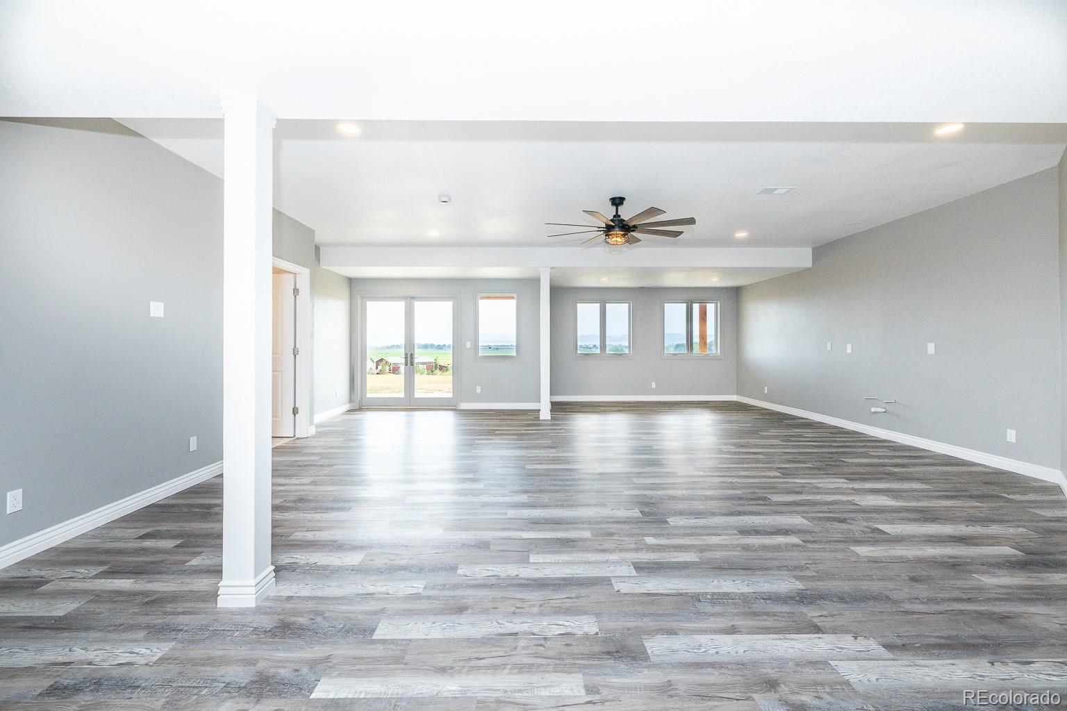 3050 Native Court Wellington, CO 80549 - Photo 34 of 50 an empty room with wooden floor and windows