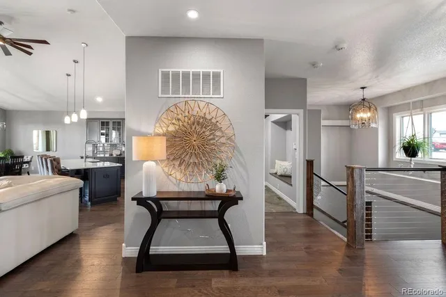 a living room with furniture and a wooden floor