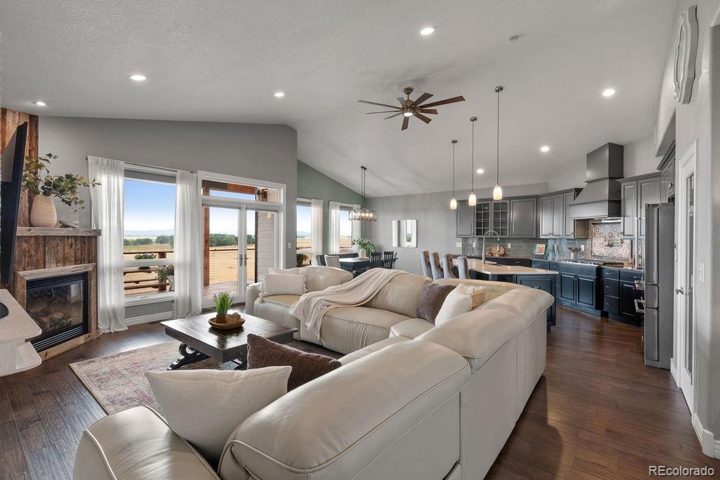 3050 Native Court Wellington, CO 80549 - Photo 7 of 50 a living room with furniture kitchen view and a fireplace