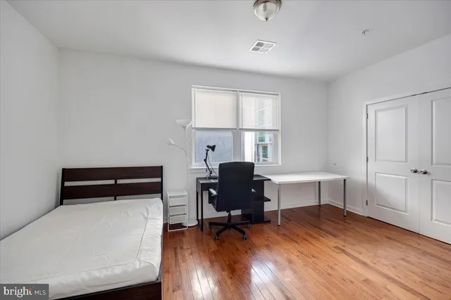 a bedroom with a bed and a window