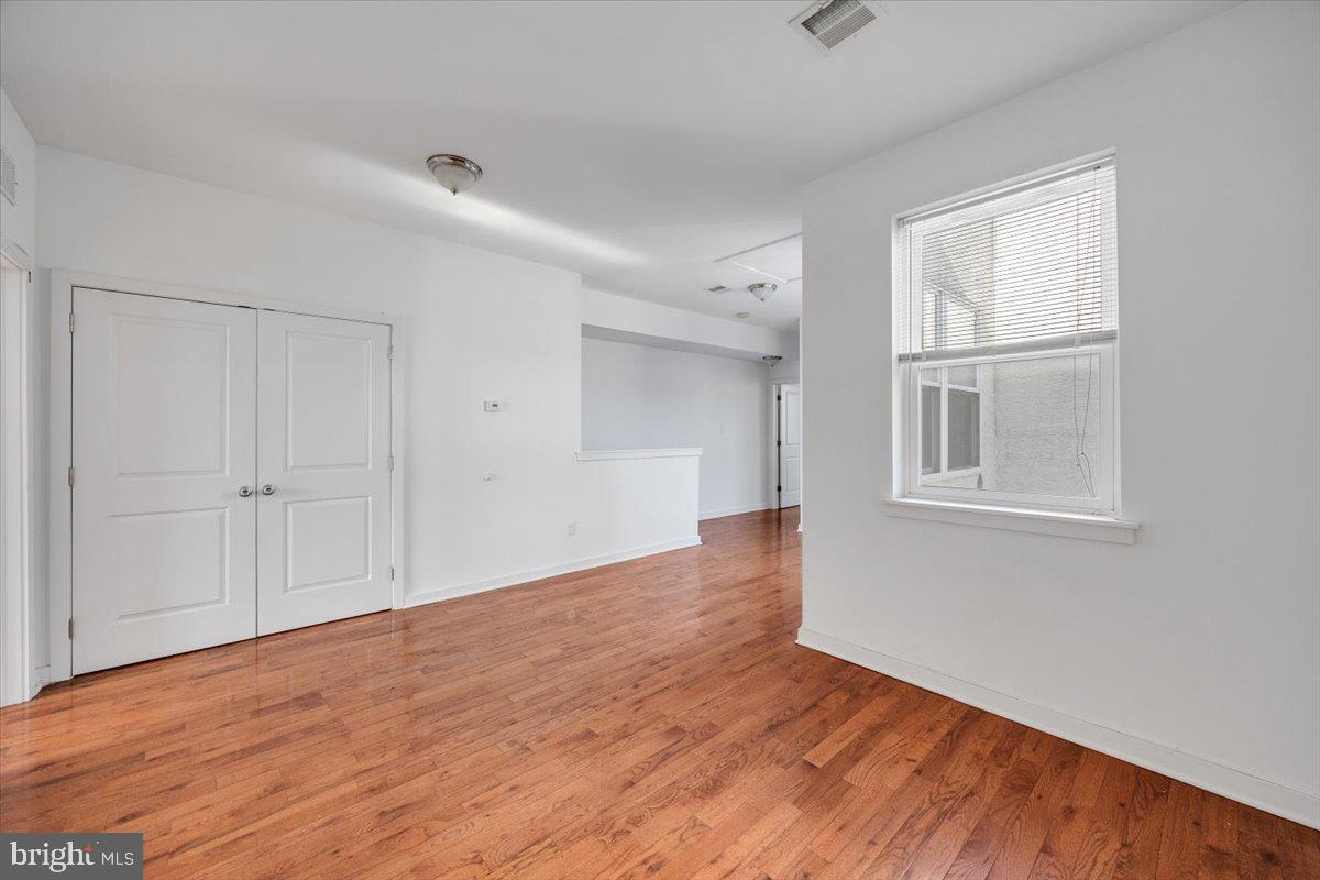 1322 North 15th Street, Unit B Philadelphia, PA 19121 - Photo 13 of 24 a view of an empty room with wooden floor and a window