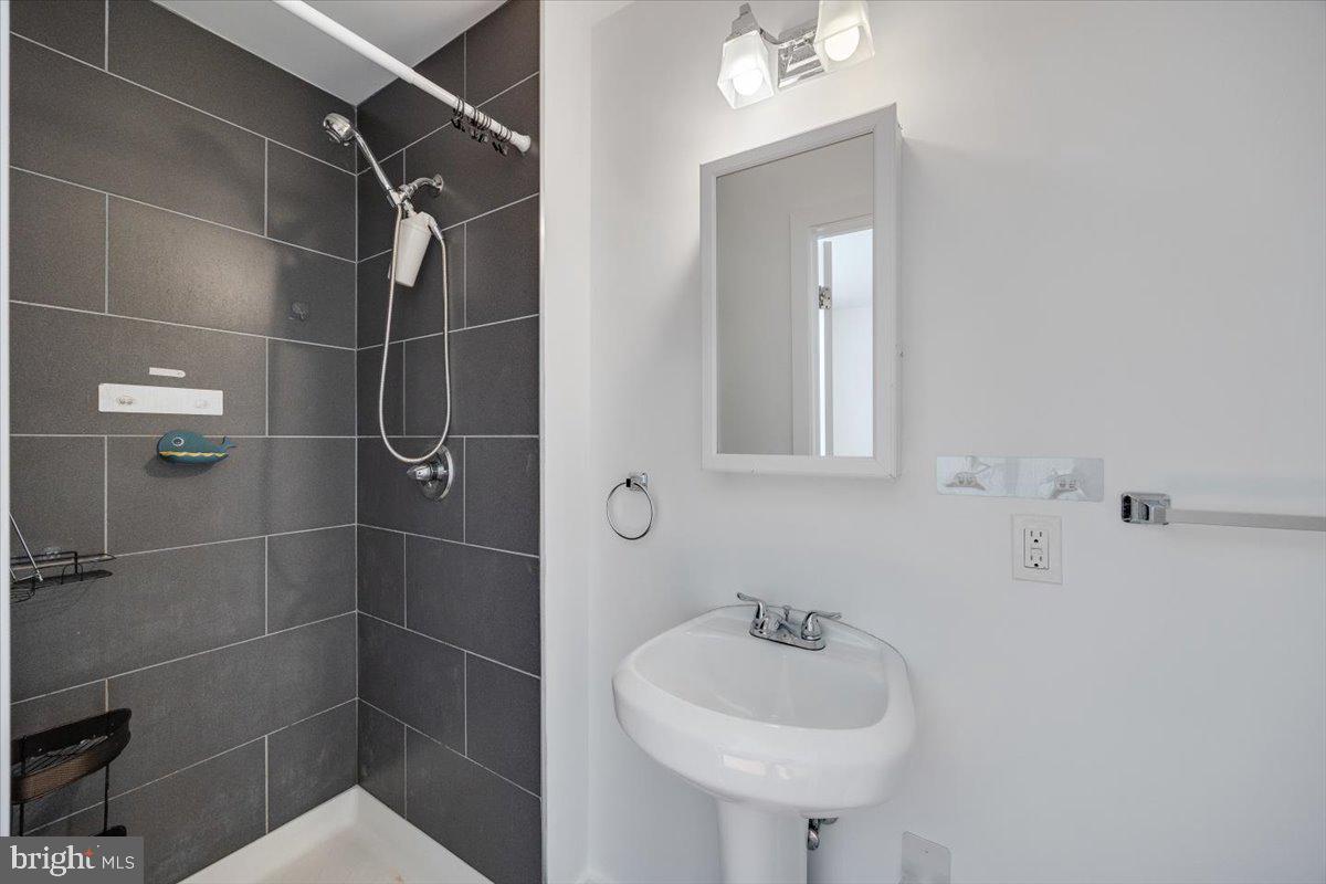 1322 North 15th Street, Unit B Philadelphia, PA 19121 - Photo 19 of 24 a bathroom with a sink shower and a mirror