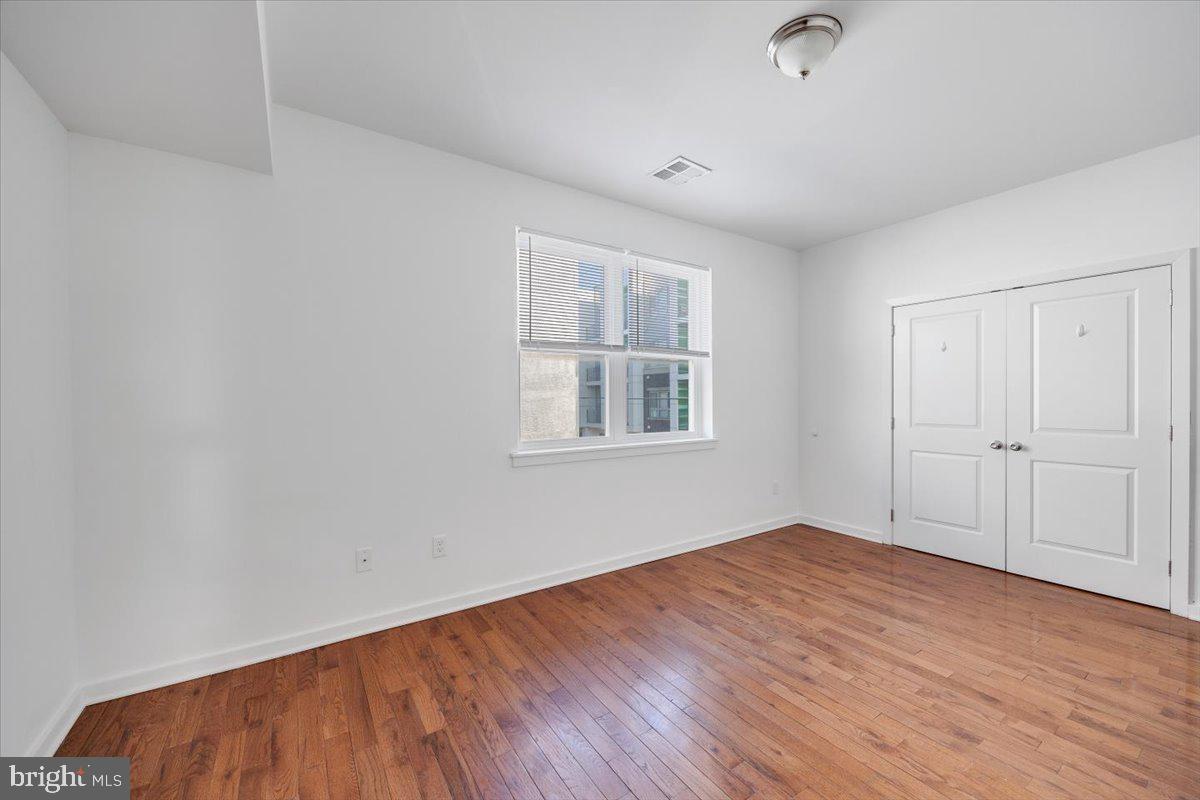 1322 North 15th Street, Unit B Philadelphia, PA 19121 - Photo 21 of 24 wooden floor in an empty room with a window