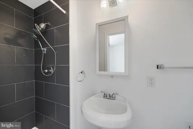 a bathroom with a sink toilet and a mirror