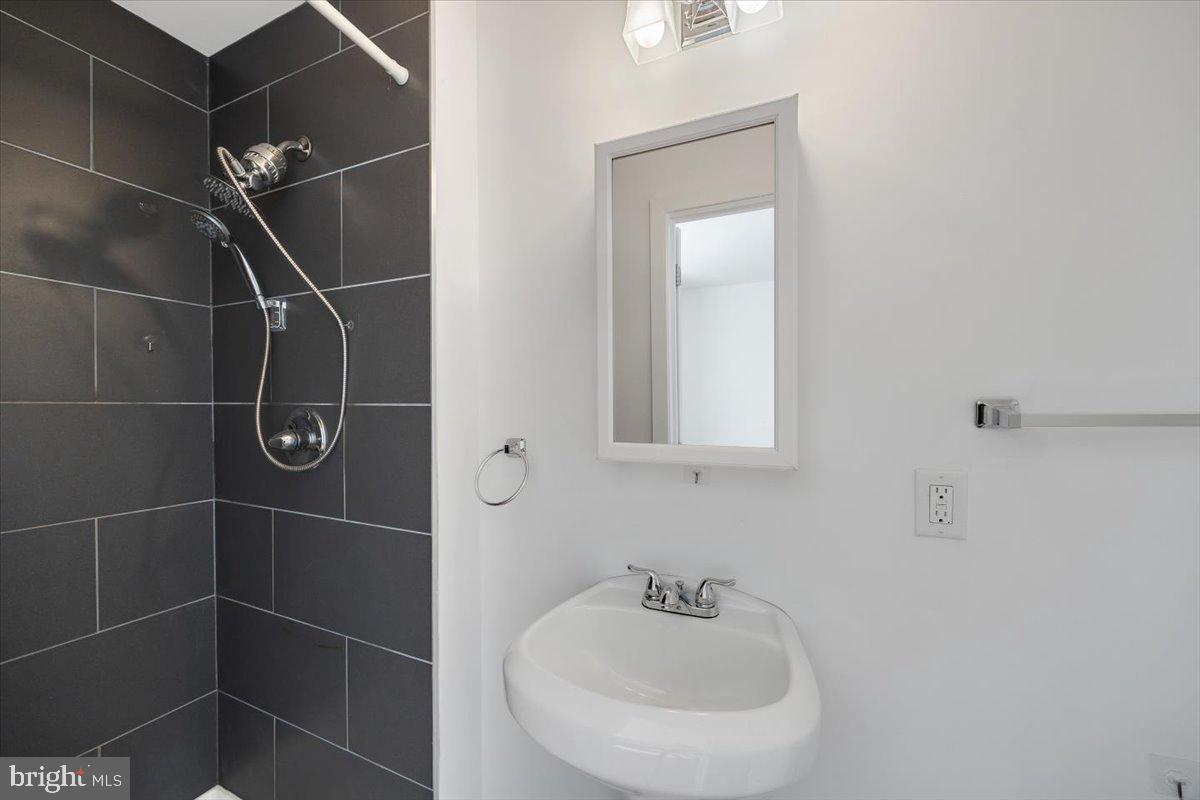 1322 North 15th Street, Unit B Philadelphia, PA 19121 - Photo 22 of 24 a bathroom with a sink toilet and a mirror