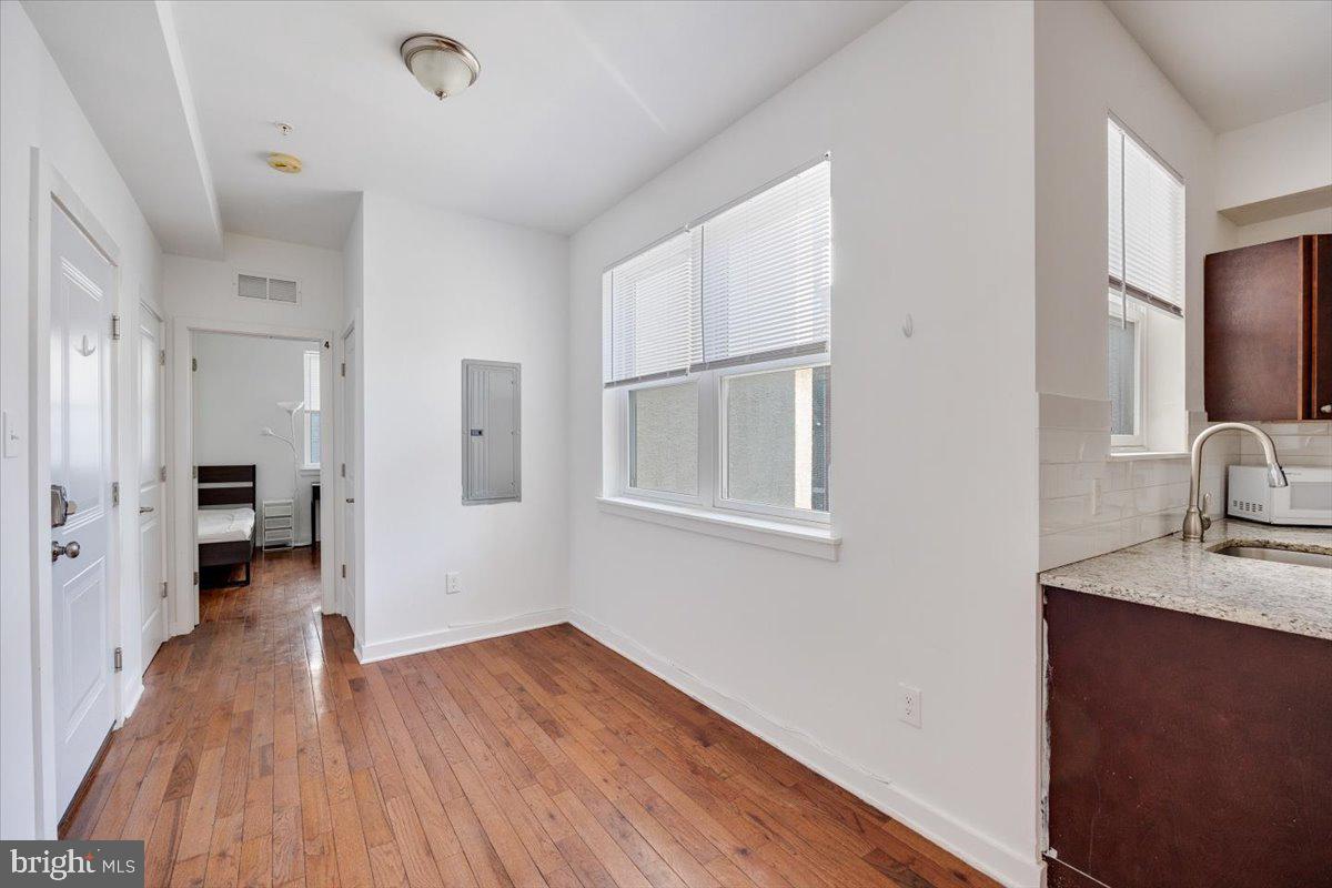 1322 North 15th Street, Unit B Philadelphia, PA 19121 - Photo 4 of 24 a view of a kitchen from the hallway with a wooden floor