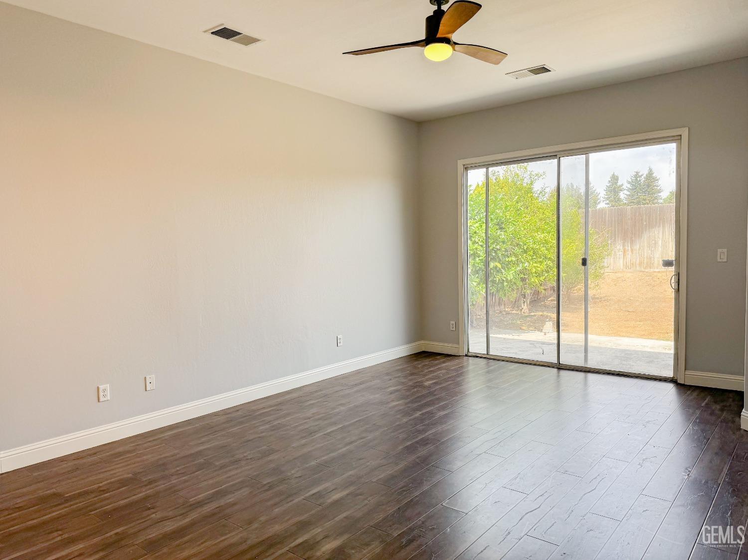 Undisclosed Address Bakersfield, CA 93312 - Photo 12 of 28 an empty room with wooden floor and windows