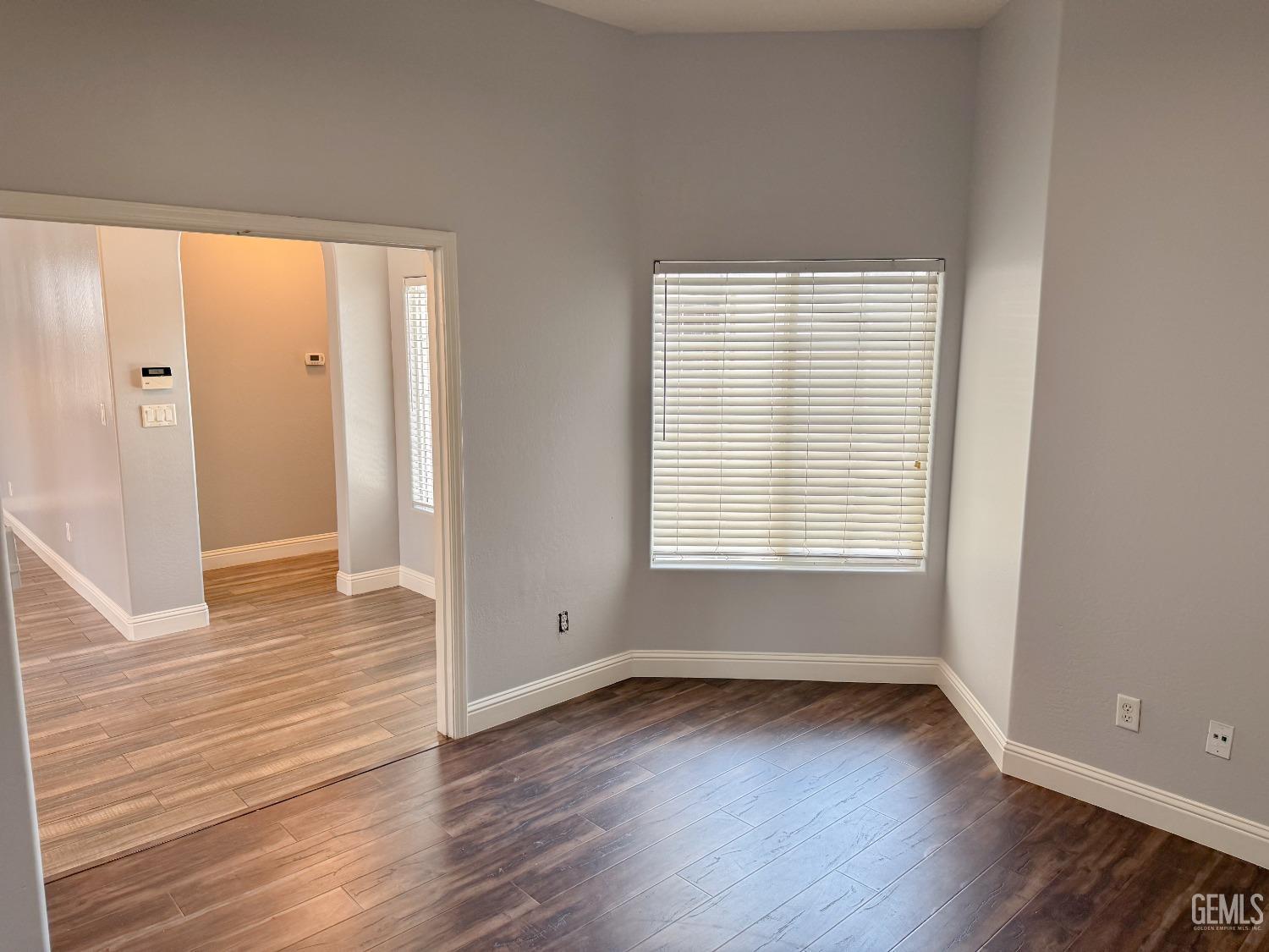 Undisclosed Address Bakersfield, CA 93312 - Photo 20 of 28 wooden floor in an empty room with a window