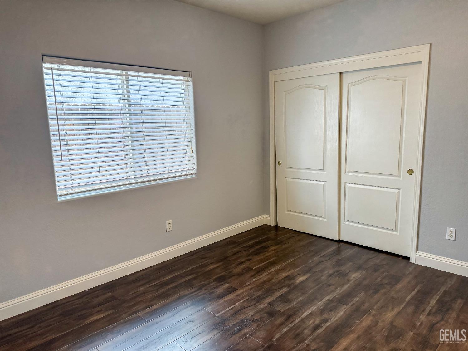 Undisclosed Address Bakersfield, CA 93312 - Photo 22 of 28 a view of an empty room with wooden floor and a window