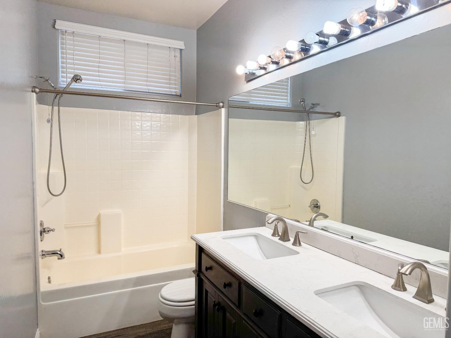 Undisclosed Address Bakersfield, CA 93312 - Photo 23 of 28 a bathroom with a granite countertop sink a toilet and shower