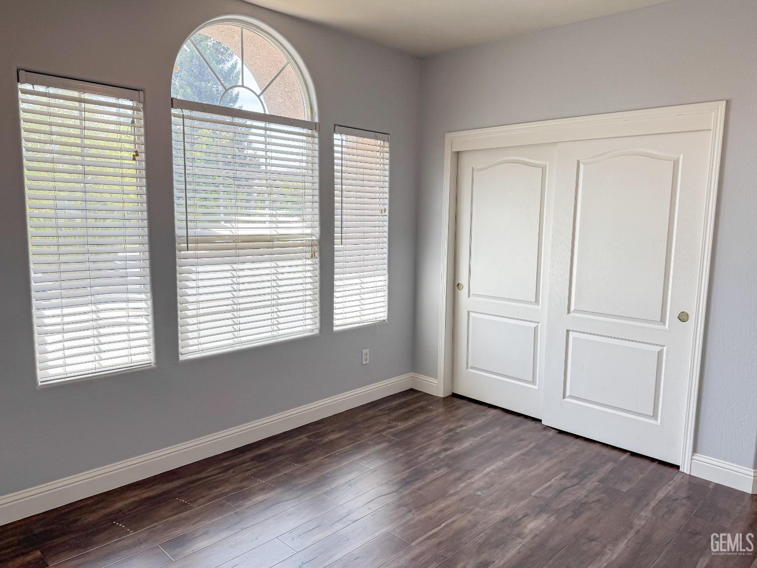 Undisclosed Address Bakersfield, CA 93312 - Photo 25 of 28 a view of an empty room with wooden floor and a window