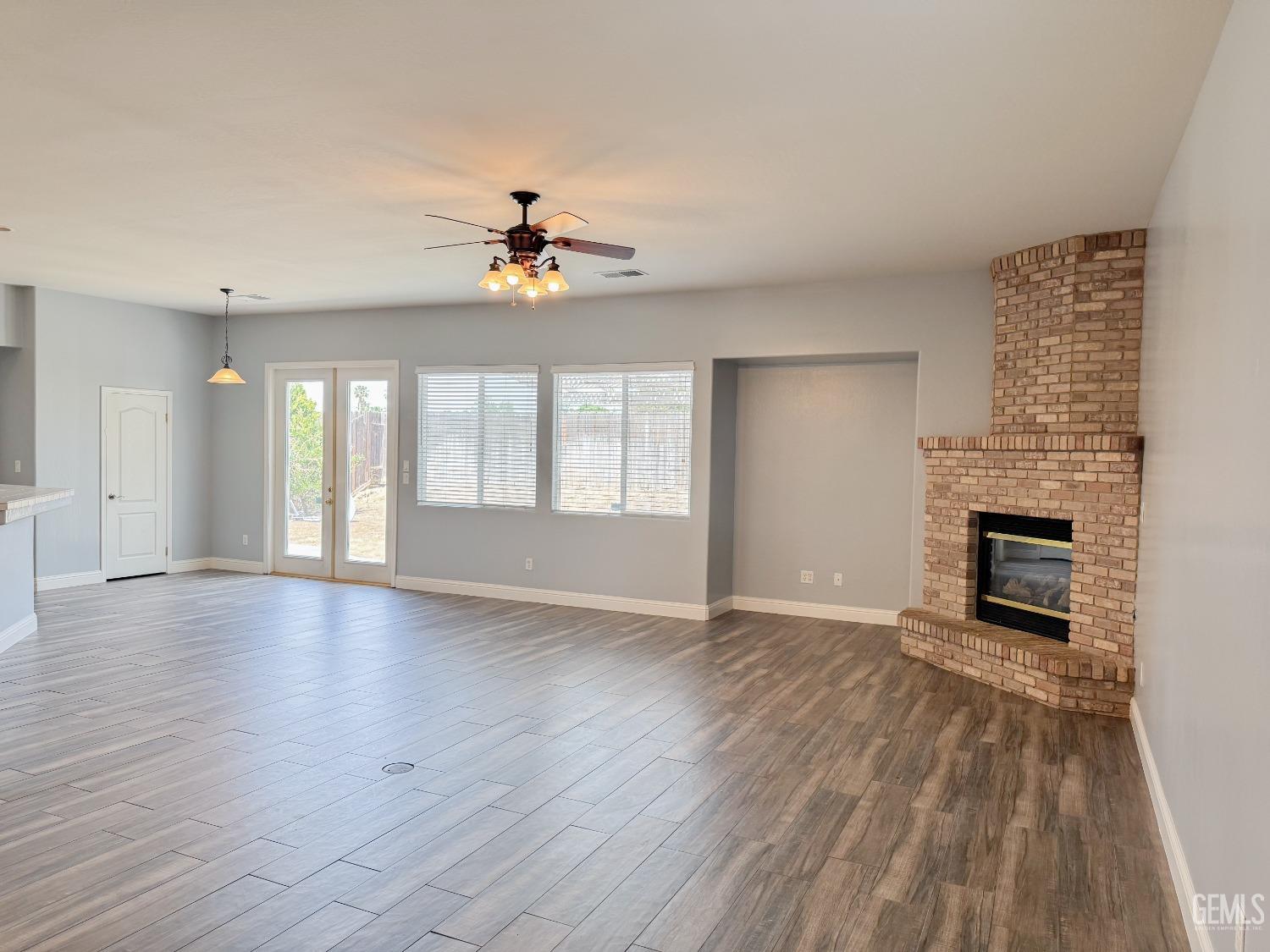 Undisclosed Address Bakersfield, CA 93312 - Photo 6 of 28 a view of an empty room with a window and wooden floor
