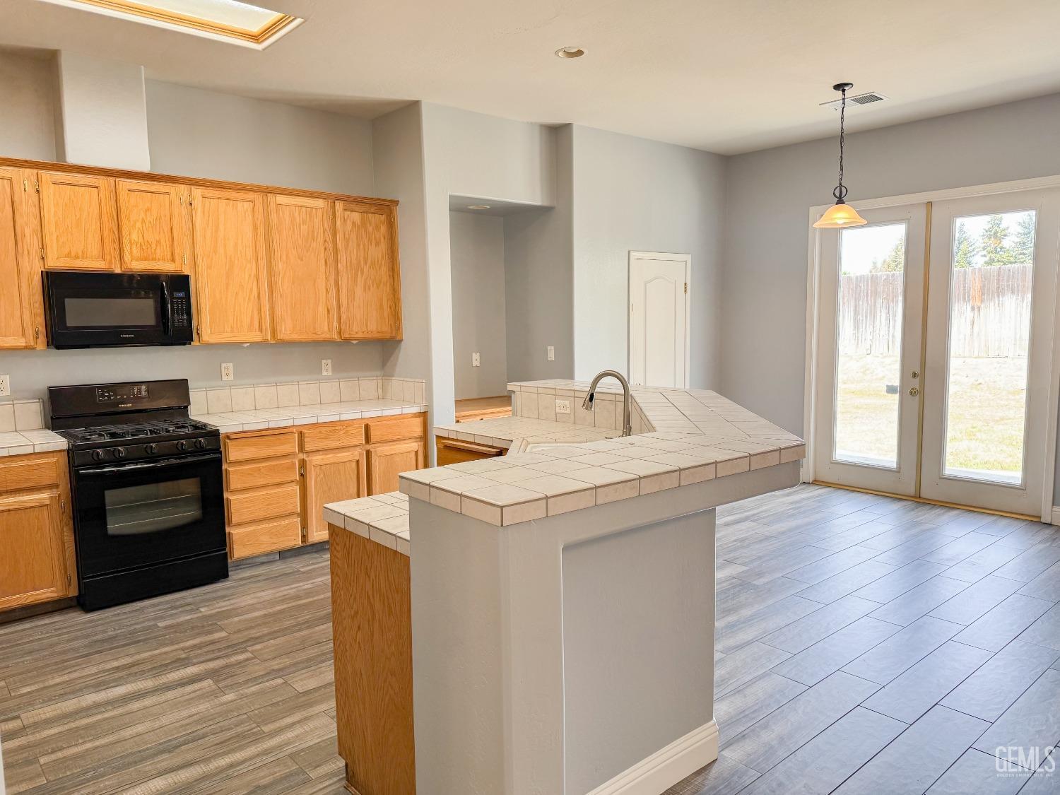 Undisclosed Address Bakersfield, CA 93312 - Photo 8 of 28 a kitchen with a sink stove top oven and cabinets