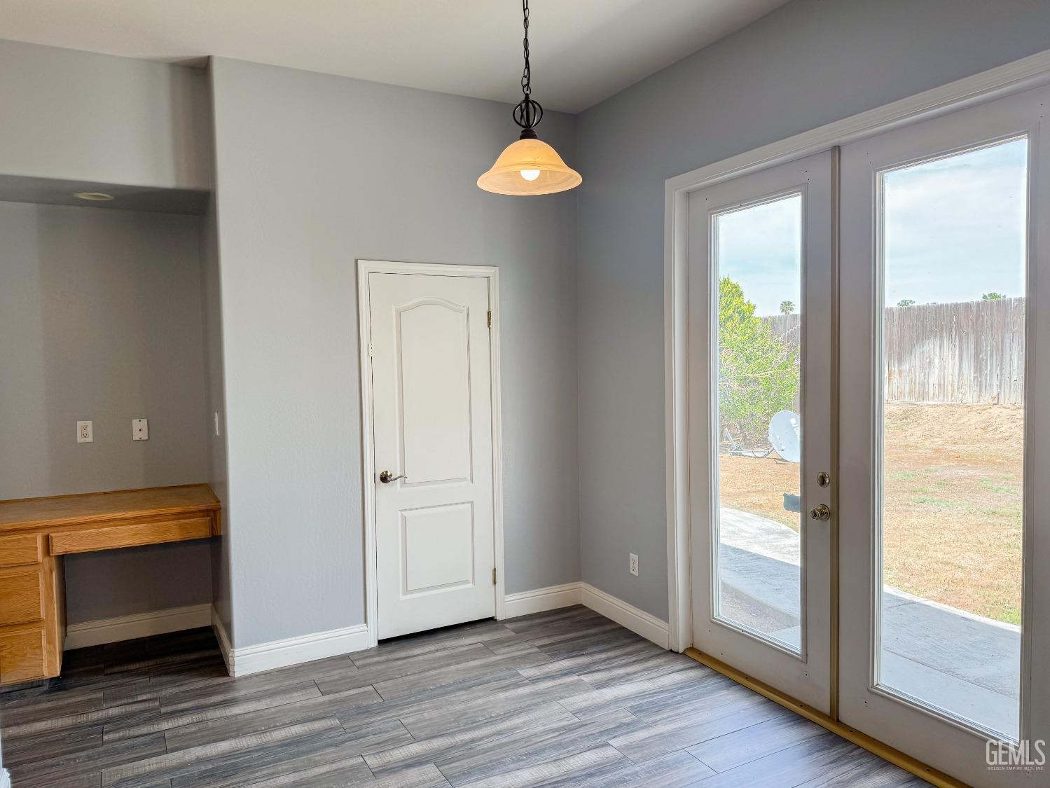 Undisclosed Address Bakersfield, CA 93312 - Photo 9 of 28 a view of an empty room with wooden floor and a window