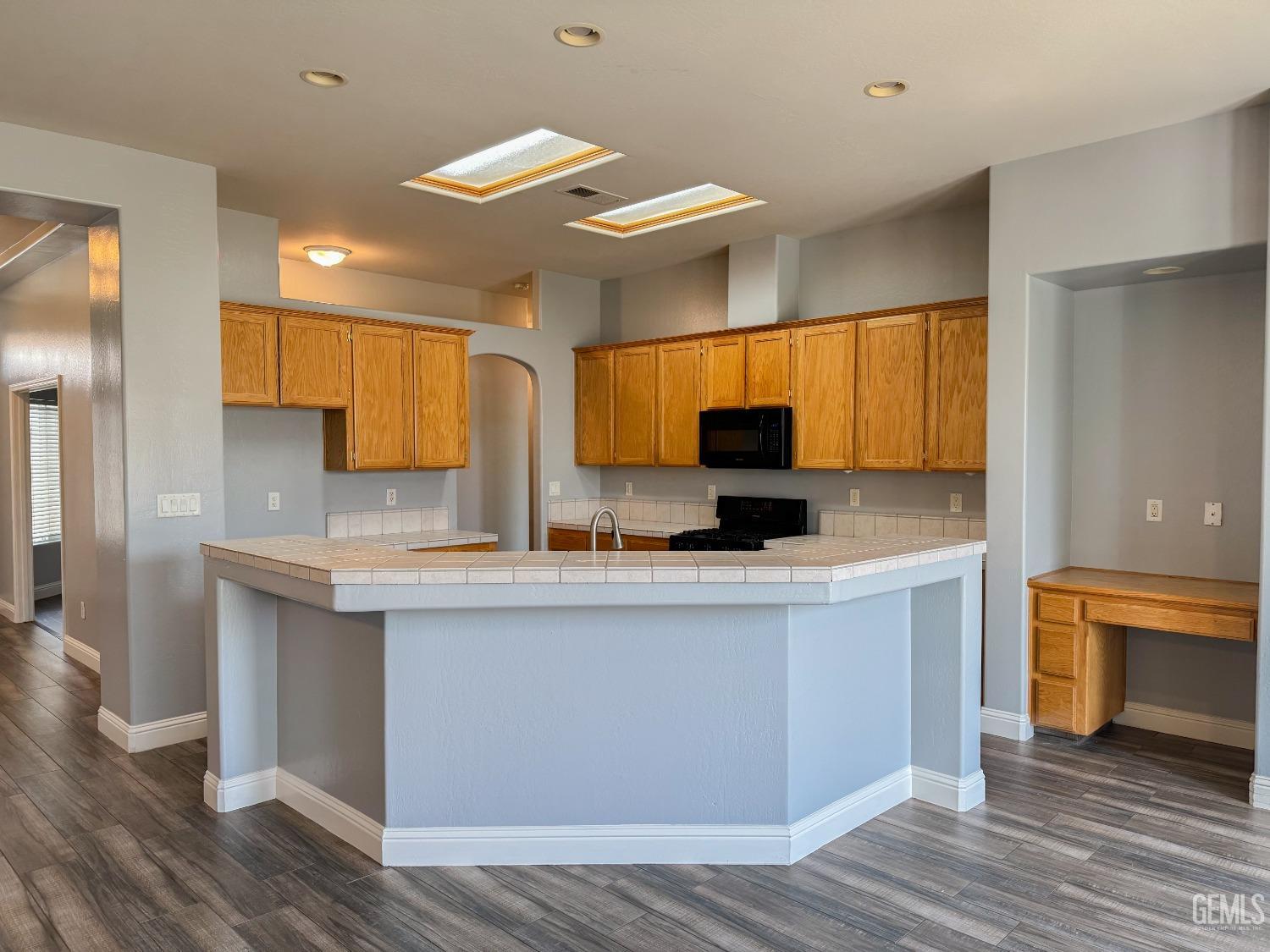 Undisclosed Address Bakersfield, CA 93312 - Photo 10 of 28 a kitchen with stainless steel appliances granite countertop a sink a stove a refrigerator cabinets and wooden floor