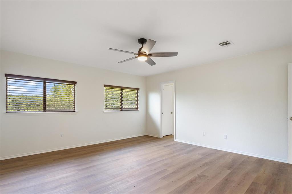 1539 Apollo Circle Round Rock, TX 78664 - Photo 11 of 26 an empty room with wooden floor and ceiling fan