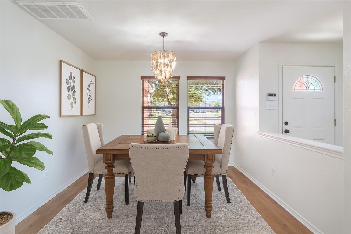 1539 Apollo Circle Round Rock, TX 78664 - Photo 7 of 26 a view of a dining room with furniture window and wooden floor