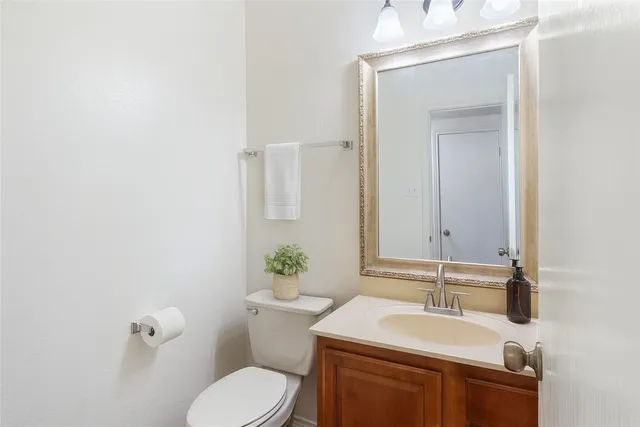 a bathroom with a sink toilet and mirror