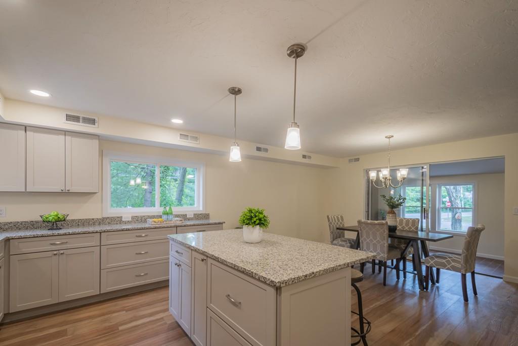 1 Kingman Road Acton, MA 01720 - Photo 16 of 42 a kitchen with a stove a sink a center island and wooden floor