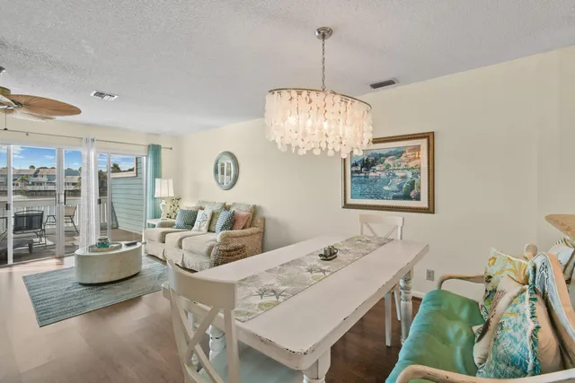 a view of a dining room with furniture and a chandelier