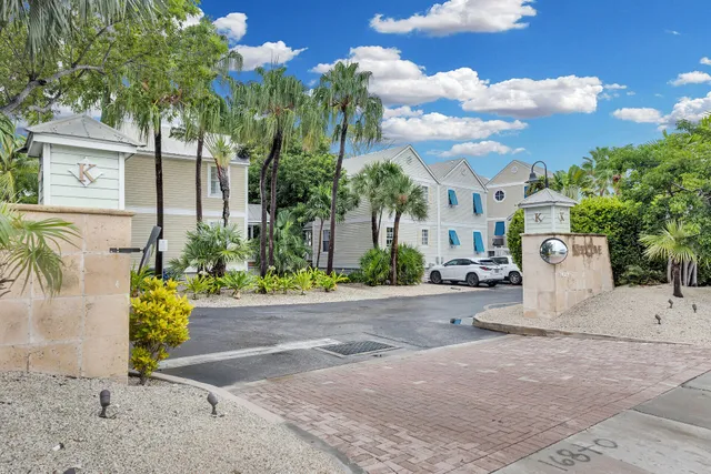 front view of a house with a yard and potted plants