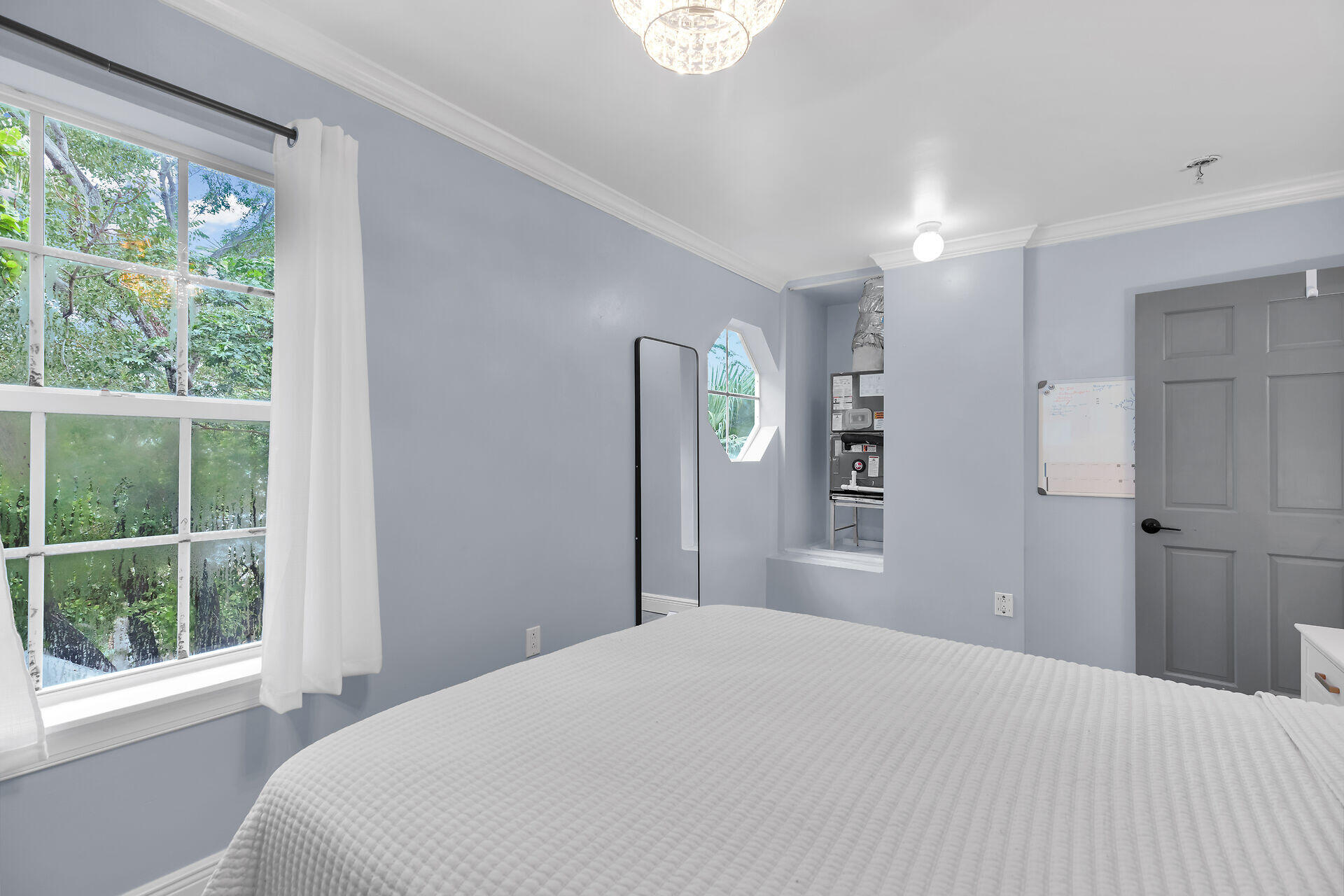 3029 North Roosevelt Boulevard, Unit 54 Key West, FL 33040 - Photo 13 of 31 a bedroom with a bed and a large window