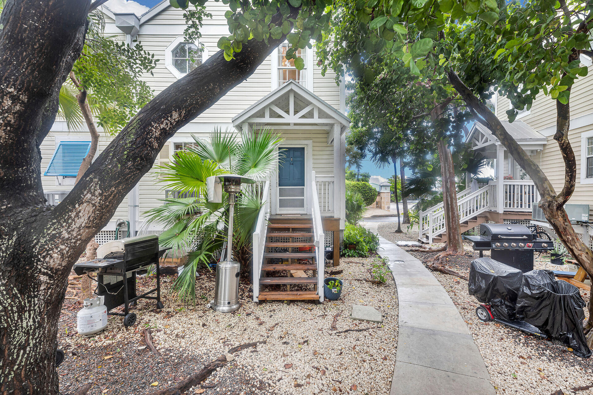 3029 North Roosevelt Boulevard, Unit 54 Key West, FL 33040 - Photo 2 of 31 a front view of a house with garden