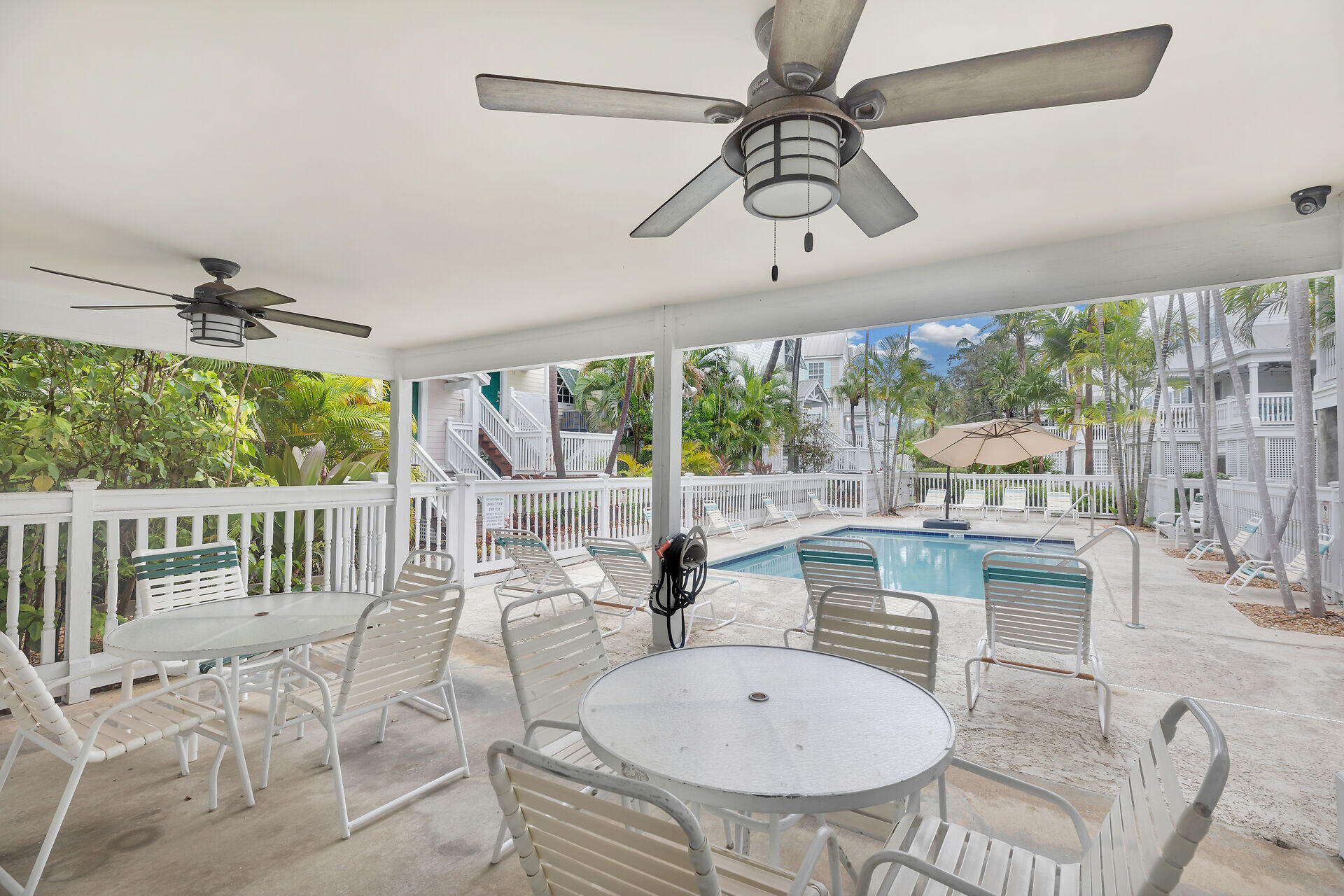 3029 North Roosevelt Boulevard, Unit 54 Key West, FL 33040 - Photo 24 of 31 a view of a dining room with furniture wooden floor and chandelier