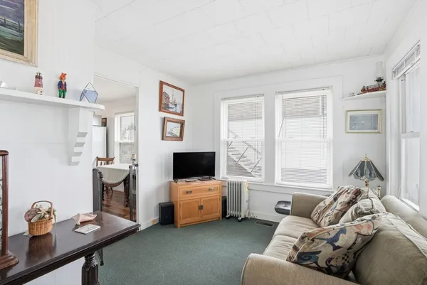 a living room with furniture and large windows