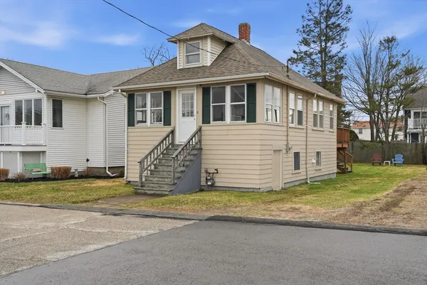 a front view of a house with a garden