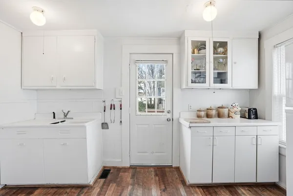 a view of kitchen with refrigerator and window
