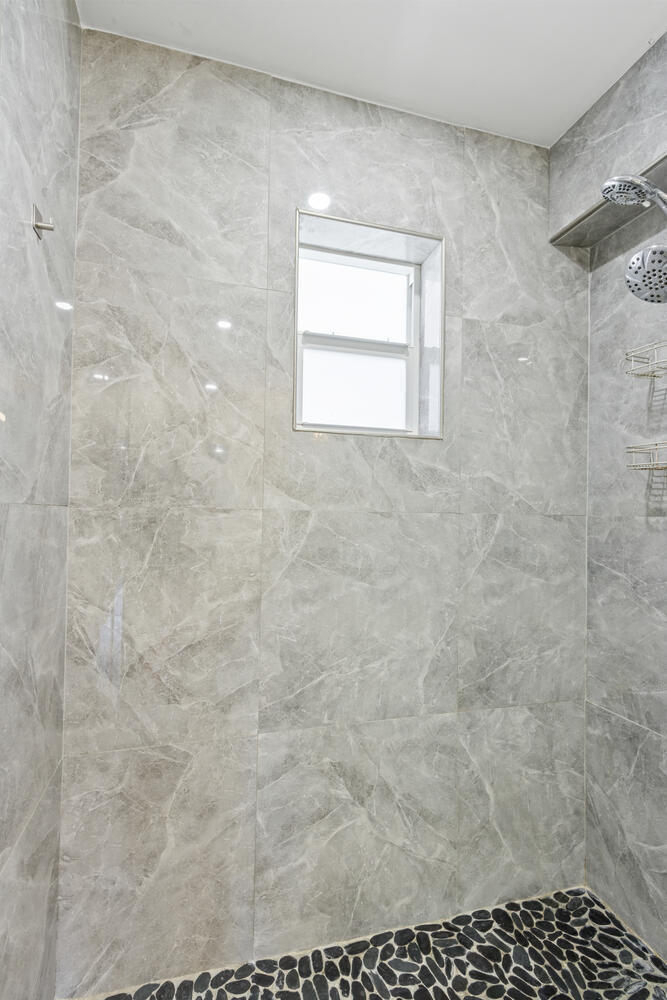 2871 North Ocean Boulevard, Unit V443 Boca Raton, FL 33431 - Photo 22 of 49 a bathroom with a window