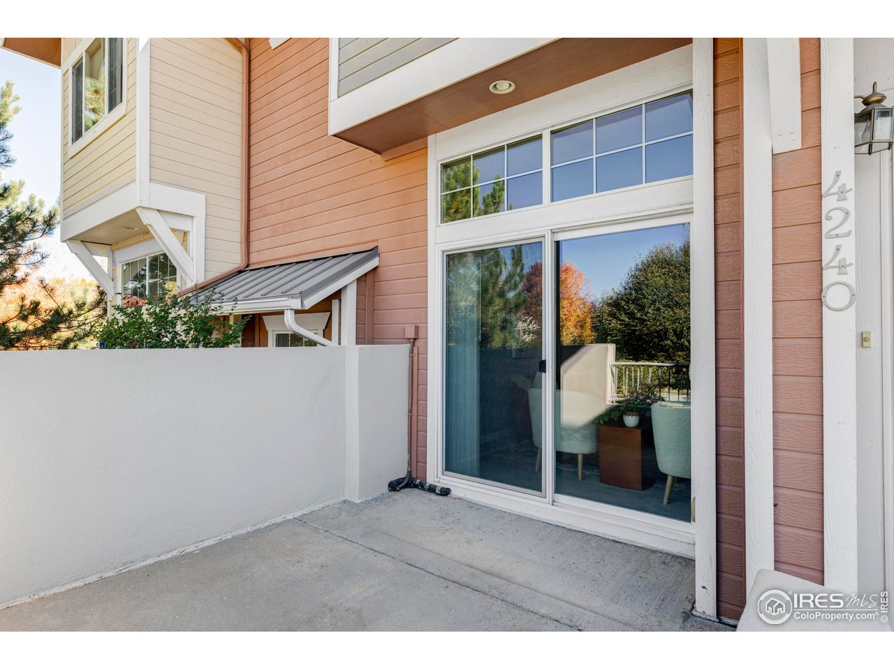 4240 Riley Drive Longmont, CO 80503 - Photo 6 of 25 A sliding glass door opens to the west-facing patio, perfect for taking in sweeping views of Long's Peak and evening sunsets.