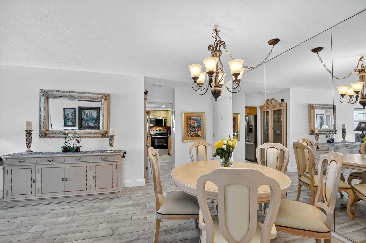 4511 South Ocean Boulevard, Unit 701 Highland Beach, FL 33487 - Photo 5 of 16 a view of a dining room with furniture and chandelier