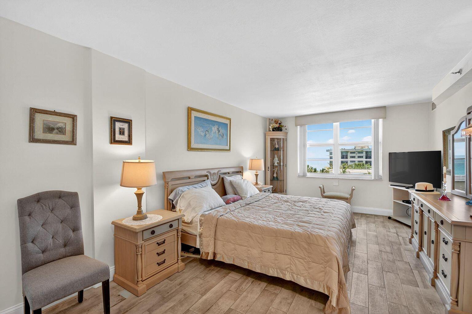 4511 South Ocean Boulevard, Unit 701 Highland Beach, FL 33487 - Photo 6 of 16 a bedroom with a bed and flat screen tv