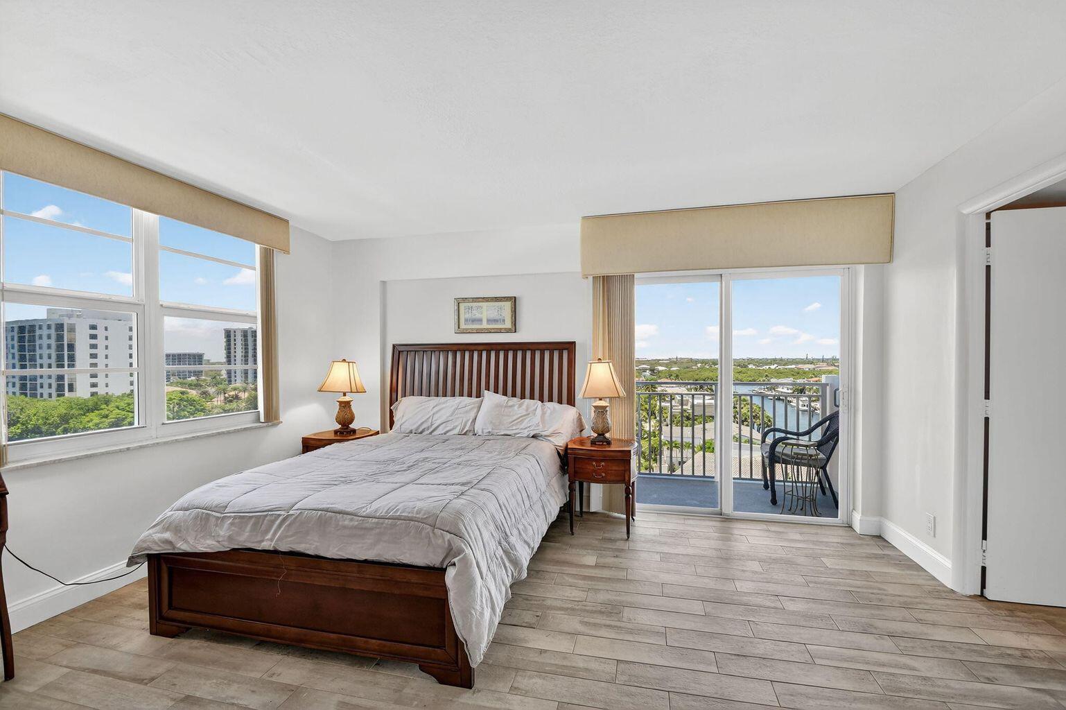 4511 South Ocean Boulevard, Unit 701 Highland Beach, FL 33487 - Photo 8 of 16 a bedroom with a bed and a large window with outer view