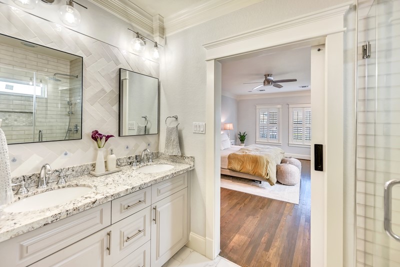 1122 East 23rd Street Houston, TX 77009 - Photo 11 of 23 Luxurious primary bath featuring dual vanities, and a spacious walk-in shower.