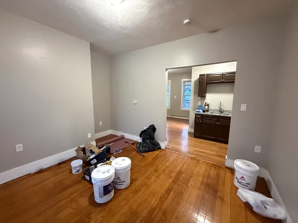 a room with wooden floor and furniture