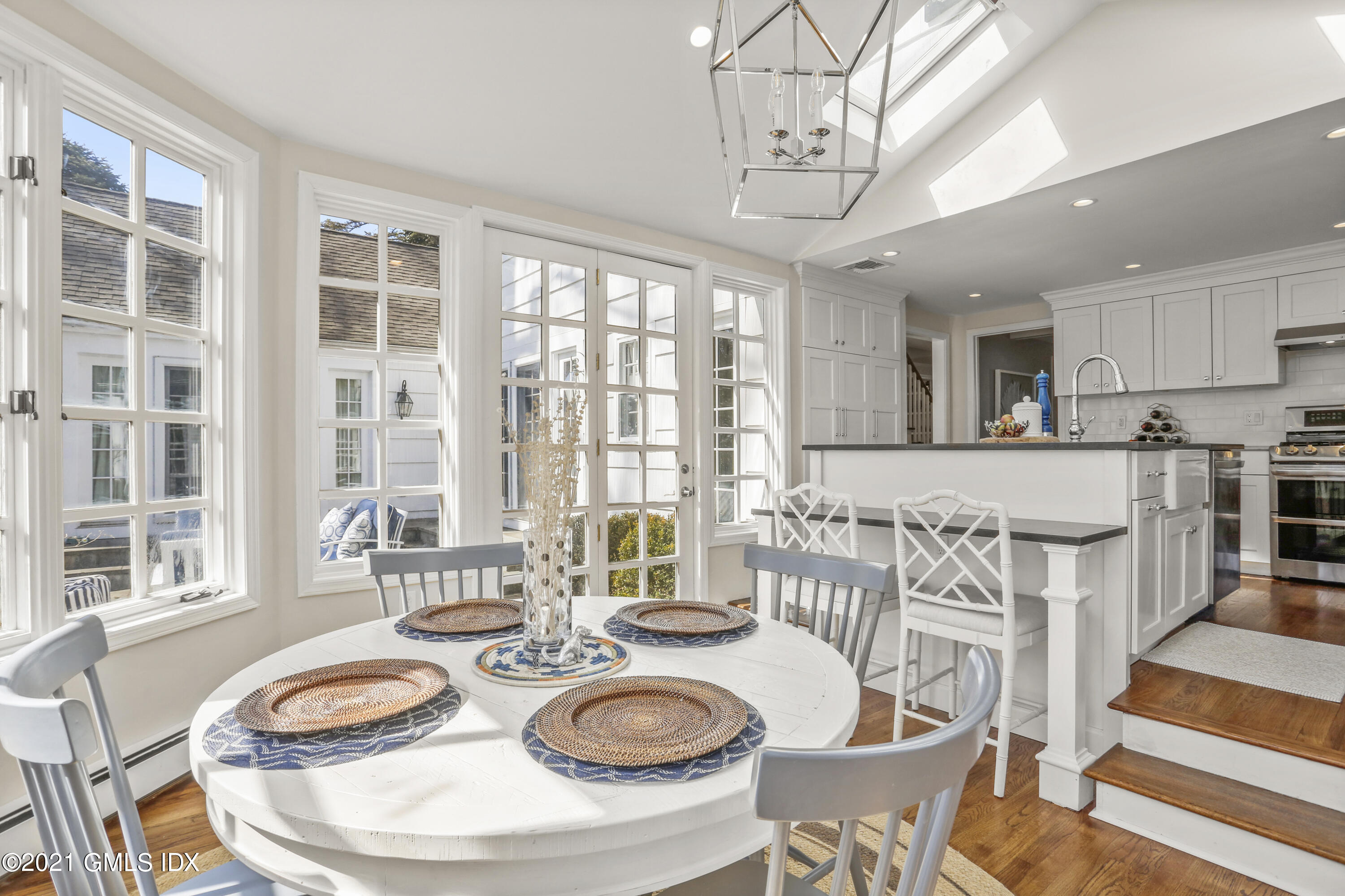 52 Winthrop Drive Riverside, CT 06878 - Photo 14 of 34 a large dining space with furniture a chandelier and wooden floor
