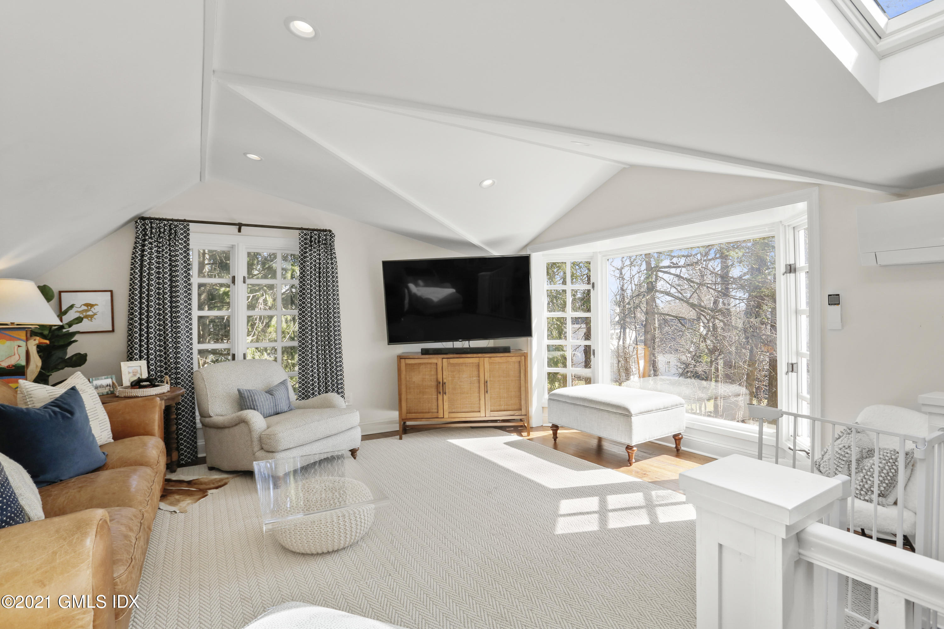 52 Winthrop Drive Riverside, CT 06878 - Photo 16 of 34 a living room with furniture a flat screen tv and a large window