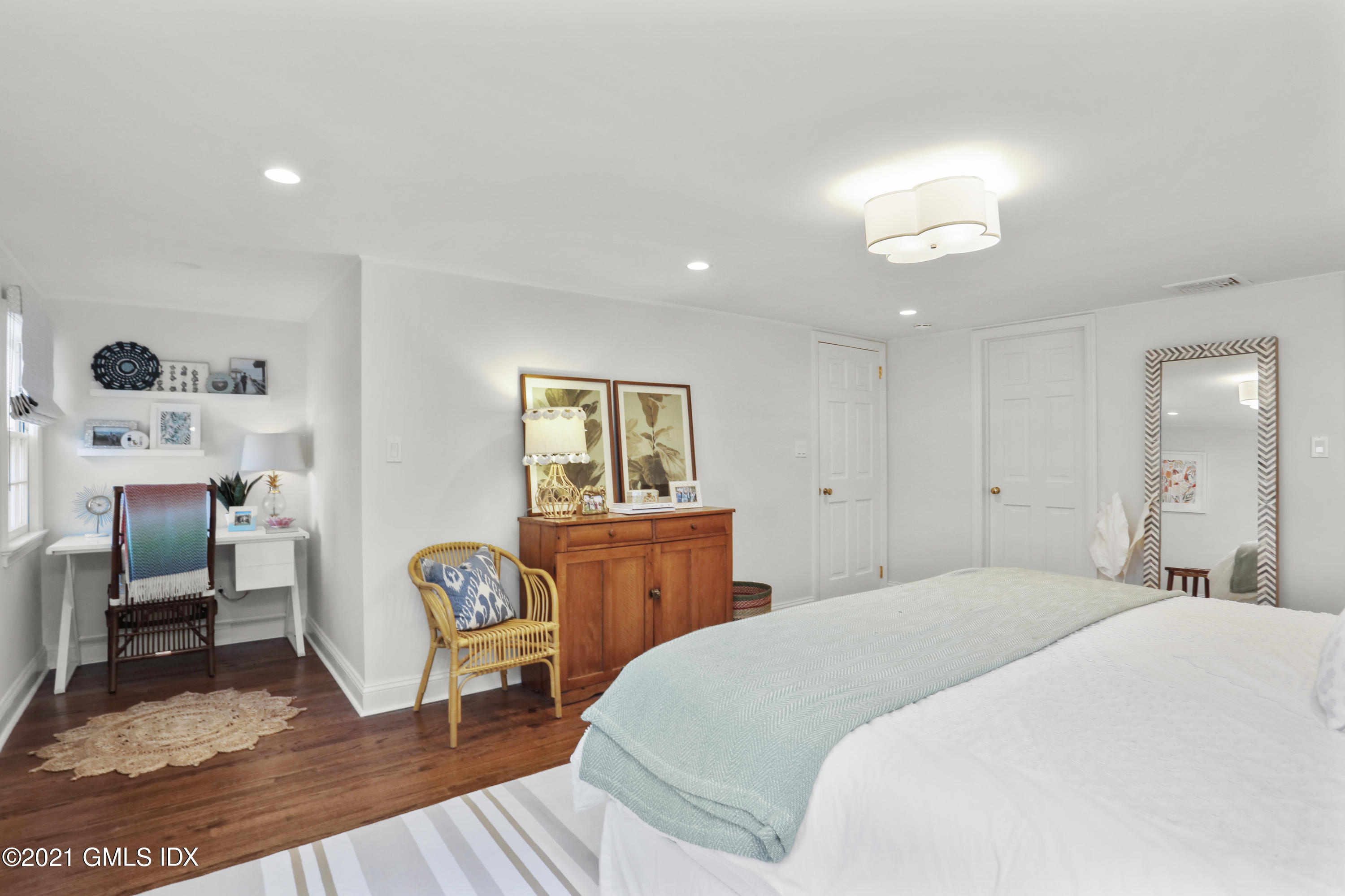 52 Winthrop Drive Riverside, CT 06878 - Photo 24 of 34 a bedroom with a bed and wooden floor