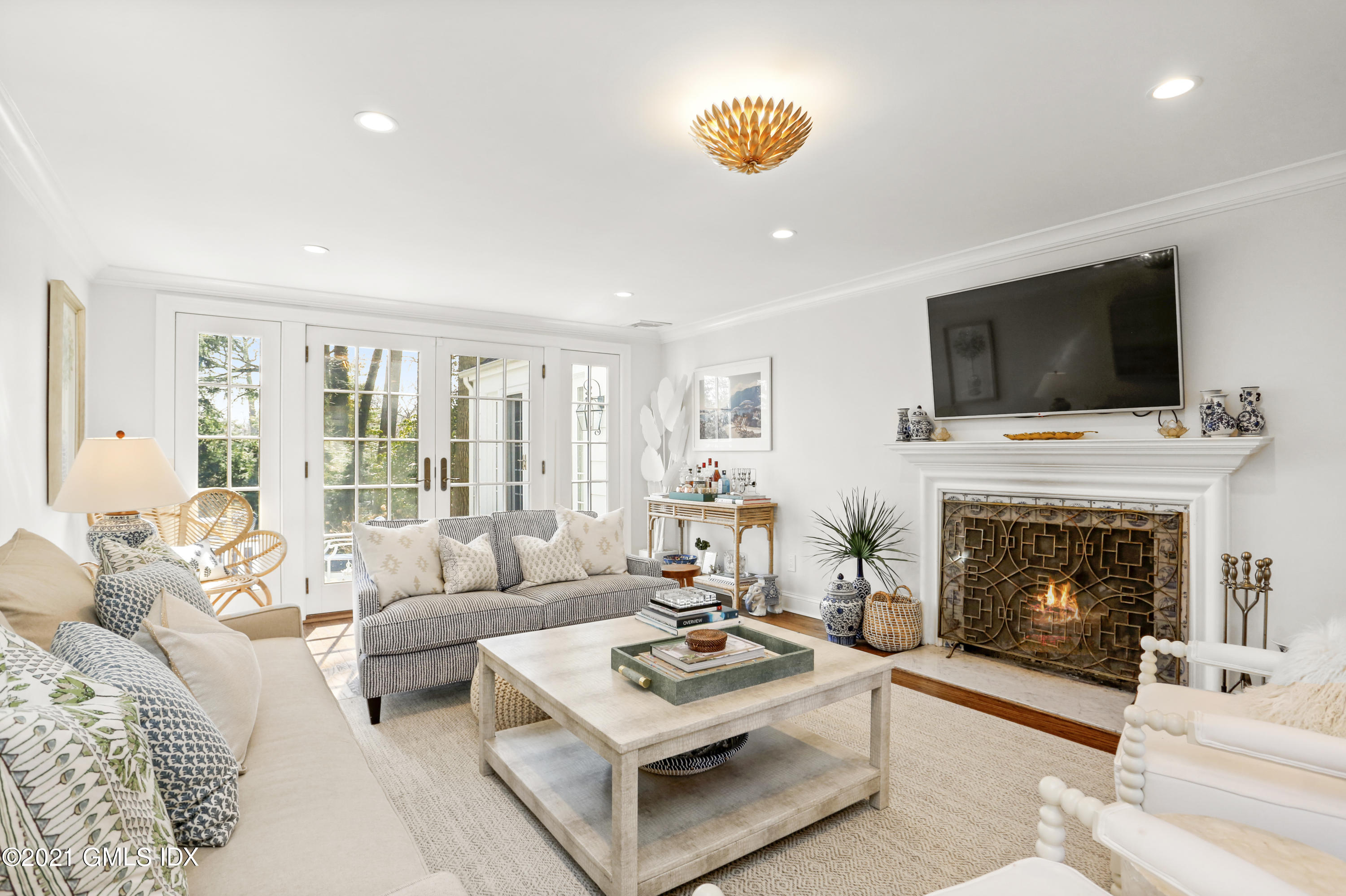 52 Winthrop Drive Riverside, CT 06878 - Photo 3 of 34 a living room with furniture a fireplace and a flat screen tv