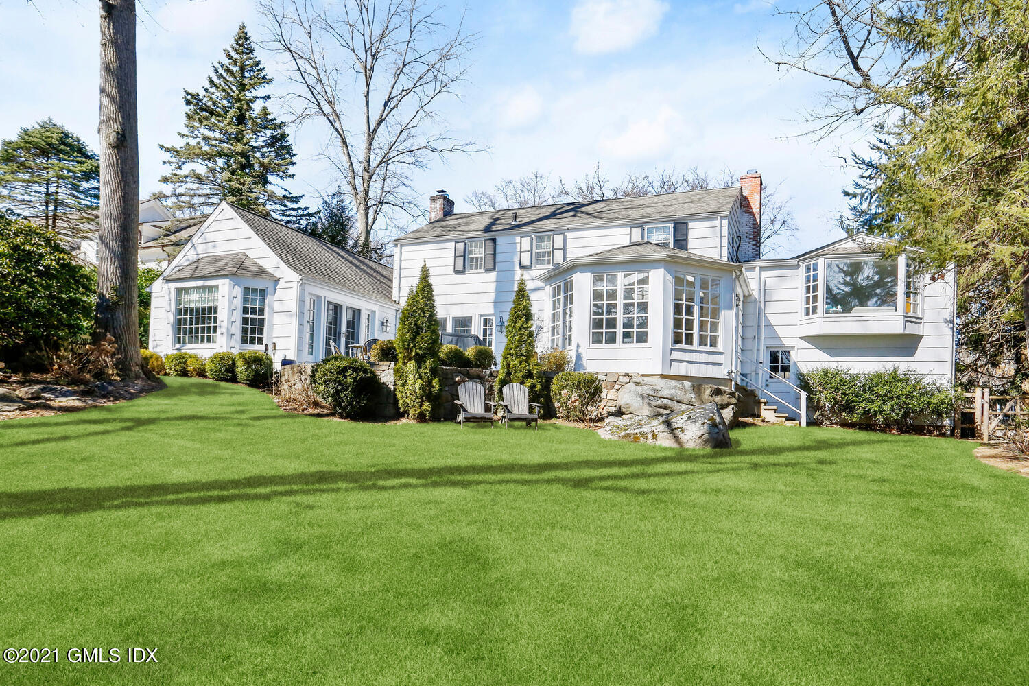 52 Winthrop Drive Riverside, CT 06878 - Photo 31 of 34 a front view of a house with a yard table and chairs