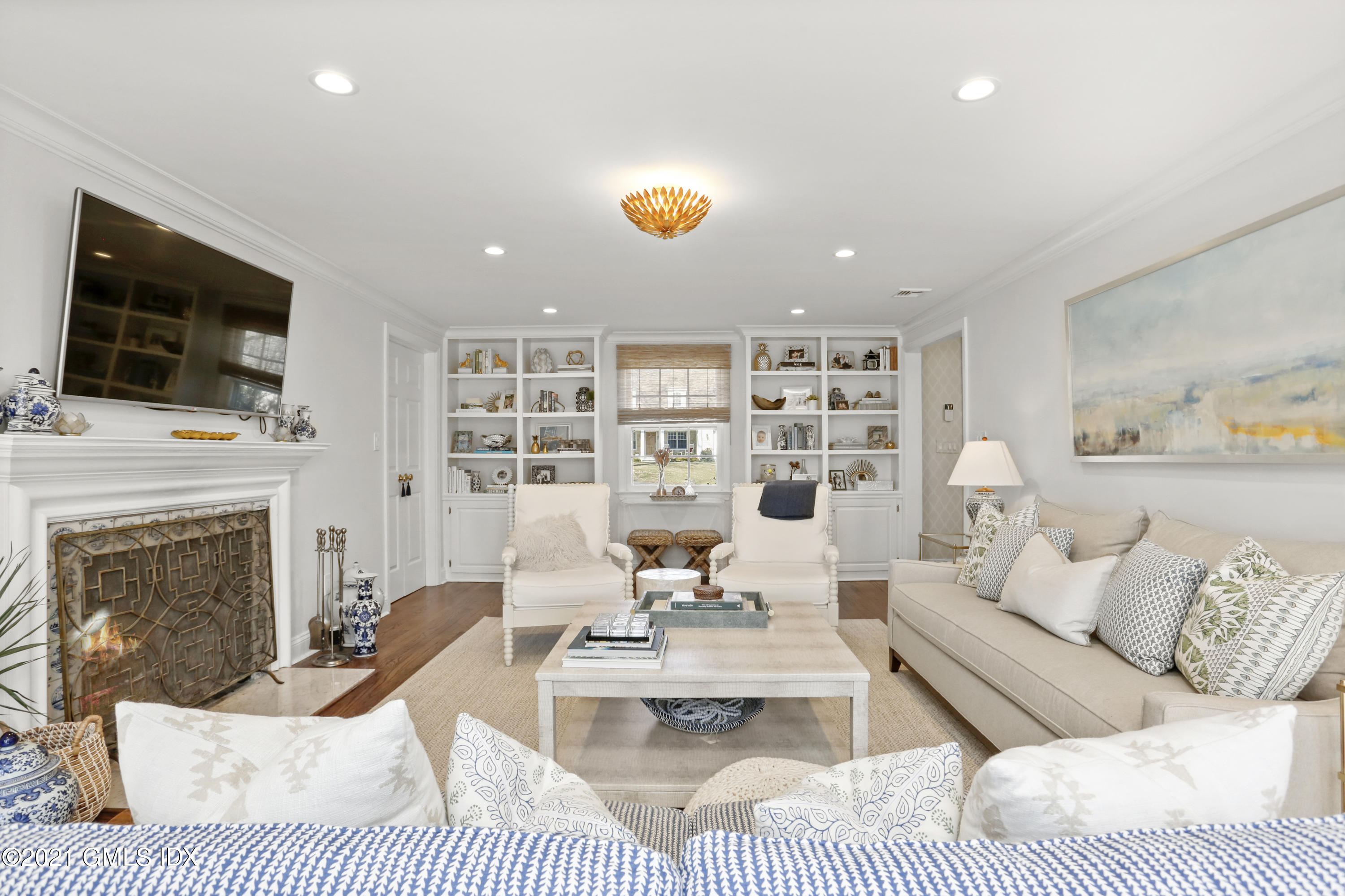 52 Winthrop Drive Riverside, CT 06878 - Photo 4 of 34 a living room with furniture a flat screen tv and a fireplace