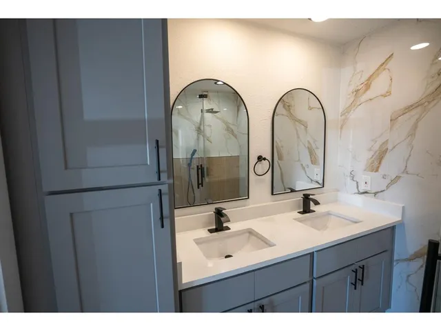 a bathroom with a double vanity sink
