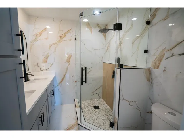 a bathroom with a sink a mirror and shower